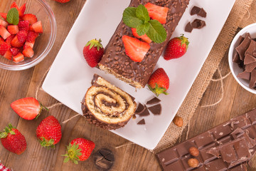 Chocolate roll with hazelnuts and strawberries. 