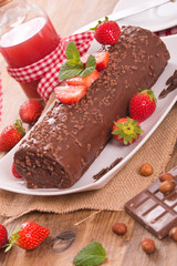 Chocolate roll with hazelnuts and strawberries. 