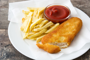 Traditional British fish and chips on wooden table. Copyspace