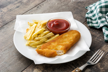 Traditional British fish and chips on wooden table. Copyspace