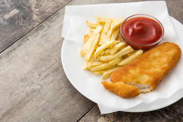 Traditional British fish and chips on wooden table. Copyspace
