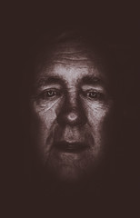 older man sadness alone in the darkside
