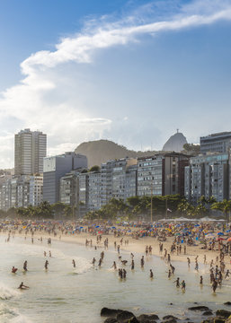 Tilt shift of Copacabana Beach in Rio de Janeiro, Brazil with Christ Redeemer Statue in background
