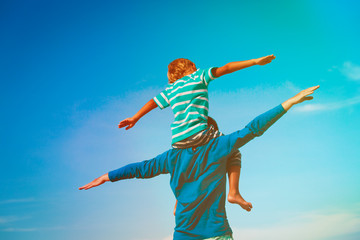 father and son having fun on sky