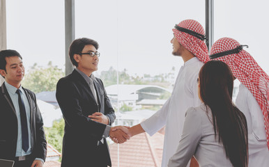 business success concept : arab business people meeting team partner ,happy hand shake communication