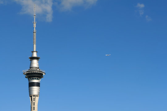 Auckland Sky Tower And Flying Airplane In Air