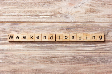 Weekend Loading word written on wood block. Weekend Loading text on table, concept
