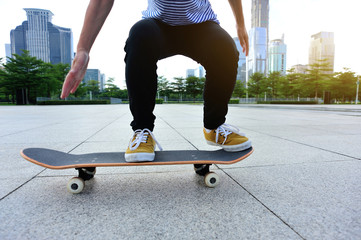 Skateboarder  ready to do a trick named ollie on city with skateboard