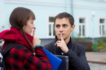 young student friends talking at college. Boy try to prove something pointing finger.