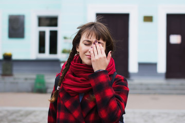 Fototapeta premium View of a Young student woman having a headache due to stress and anxiety
