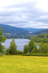 Obraz premium Summer landscape glassy surface of a calm river and trees 
