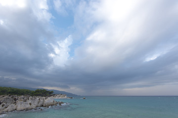 Fototapeta na wymiar Dramatic rainy sky and clouds over sea in Greece