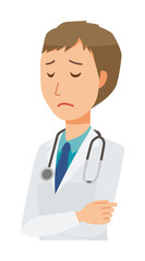 Fototapeta premium A young male doctor in a white suit is depressed