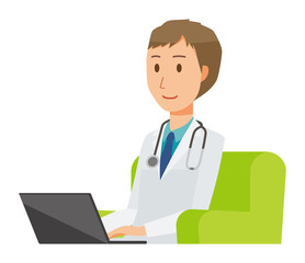 A young male doctor wearing a white suit sitting on a sofa and operating a laptop computer