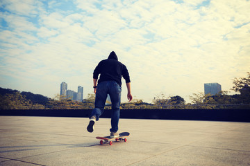 female skateboarder riding with skateboard on city