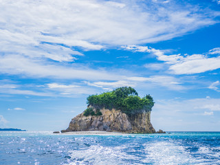 Landscape of turquoise sea with cloudy sky and wonderful island shape.