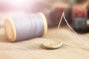 needle with thread and buttons