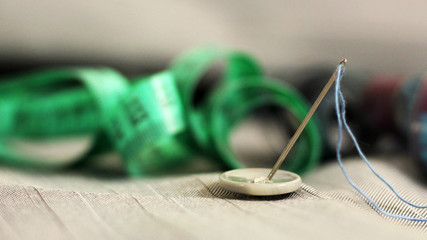 needle with thread and buttons
