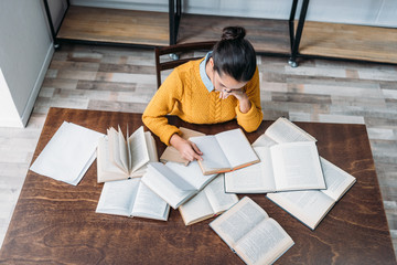 high angle view of young student girl preparing for exam at library