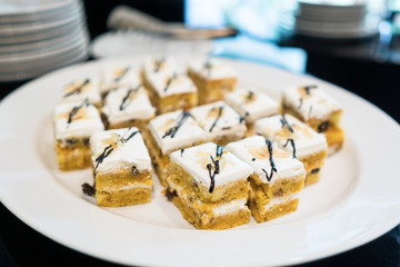 Plenty of cakes on White dish in Party of Hotel room