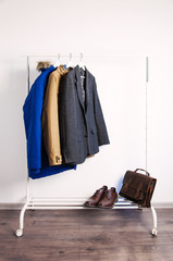 Outer clothing on the shoulders on the dressing counter. Shoes and bags on the floor. On a white background.