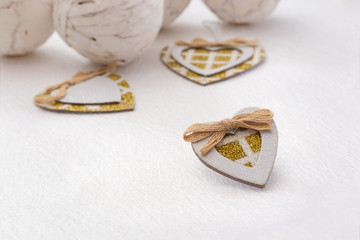 A small paper heart with gold sparkles. Very light background with a heart for a festive concert. Soft focus. Copy space.