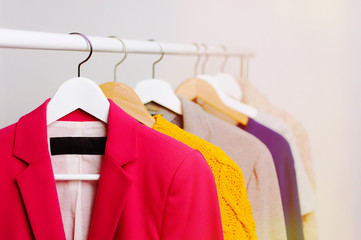 Bright clothes on the shoulders, for sales. On a light background.