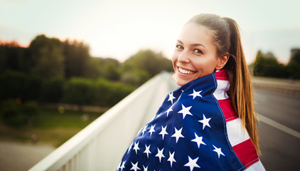 Beautiful woman wrapped in American flag