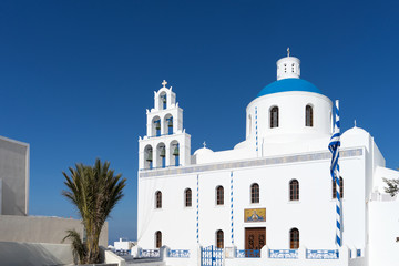 White blue orthodox church of Panagia Platsani, in the village of Oia. Santorini