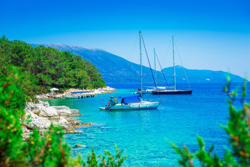 Beautiful landscape over the sea with boats and mountain in background in Lefkada island, Greece
