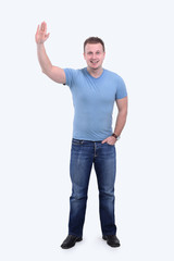 Naklejka premium smiling young man raising hand up