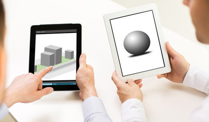 designers with 3d models on tablet pc screens