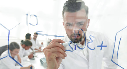 close up of a Man scientist working with formulas