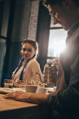 man pouring hot water into bowl with grind coffee during coffee food function at coffee shop