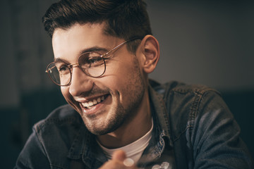 Obraz premium portrait of cheerful man in eyeglasses looking away
