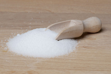Salt on table with wooden spoon

