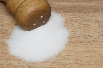 Salt shaker on wooden table
