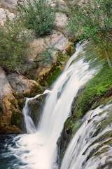 Obraz premium Top view of a small waterfall on a river in summer