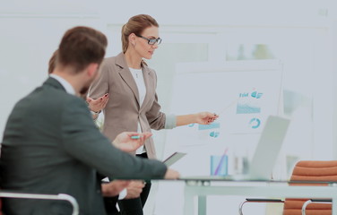 Successful businesswoman in suit at the office leading a group