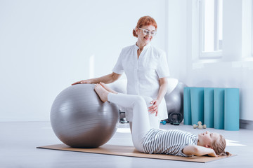 Kid and doctor during rehabilitation © Photographee.eu