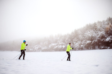Senior couple cross-country skiing.