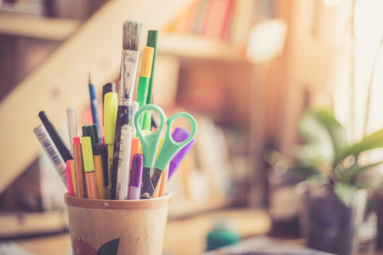 Kreativzubeh&ouml;r auf Schreibtisch. Stiftehalter mit Scheere, Bleistift, Filzstifte usw.