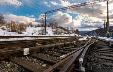 old railroad in winter mountain on a cloudy day. transportation background