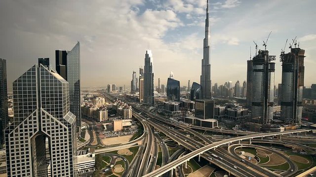 Spectacular daytime skyline of downtown Dubai, UAE. Scenic aerial view of famous highway intersection. Transportation and travel background 