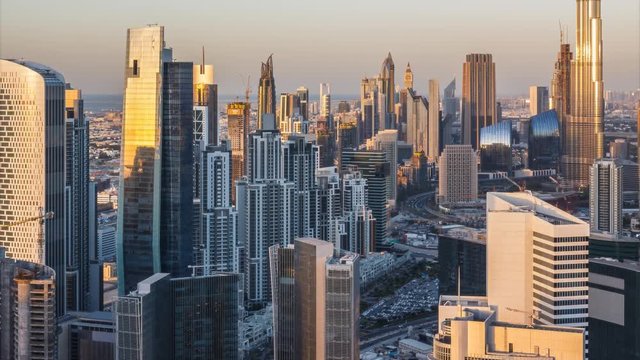 Beautiful daytime skyline of a big futuristic city. Scenic aerial view of Dubai skyscrapers. Day-to-night transition time lapse. 