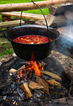 traditional Hungarian Goulash soup in cauldron. meal cooked outdoors on an open fire. delicious and healthy food popular in Central Europe