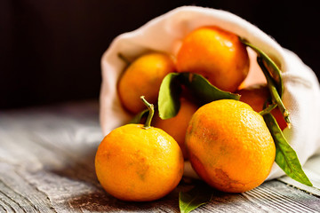 Mandarine orange or tangerine on wooden board