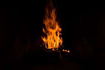 fire isolated in black woods fireplace for background dark