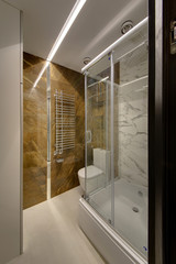 A glass shower cabin with sliding doors