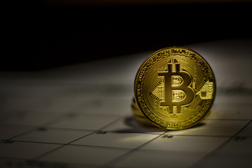 Golden crypto coin. Bitcoin on a calendar